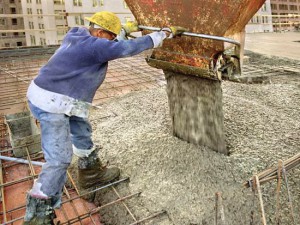 Construction worker pouring concrete